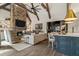 Open living room with stone fireplace, vaulted ceilings, and a view into the kitchen area at 2305 Whiting Bay Cts, Kennesaw, GA 30152