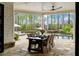 Covered outdoor dining area with a view of the pool and lush landscaping, perfect for outdoor living at 2305 Whiting Bay Cts, Kennesaw, GA 30152