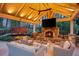 Cozy outdoor living area with a fireplace, seating, and grill at 2305 Whiting Bay Cts, Kennesaw, GA 30152