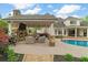 Exterior shot of covered patio area with fireplace, outdoor kitchen, and pool at 2305 Whiting Bay Cts, Kennesaw, GA 30152