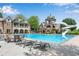 Gorgeous community pool with slide, lounge chairs, and adjacent clubhouse offers resort-style living at 2305 Whiting Bay Cts, Kennesaw, GA 30152