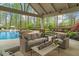 Relaxing poolside patio with covered seating area and lush landscaping at 2305 Whiting Bay Cts, Kennesaw, GA 30152