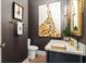 Stylish powder room with modern fixtures, elegant artwork, and designer wallpaper at 2305 Whiting Bay Cts, Kennesaw, GA 30152