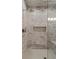 Modern shower featuring floor-to-ceiling marble tiling and a built-in niche at 2305 Whiting Bay Cts, Kennesaw, GA 30152