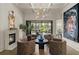 Inviting sitting room with a fireplace, plush chairs, and view of the outdoor dining area at 2305 Whiting Bay Cts, Kennesaw, GA 30152