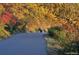 Couple walking their dog down a quiet walking trail with trees showing beautiful fall colors at 2305 Whiting Bay Cts, Kennesaw, GA 30152