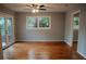 Bright bedroom with hardwood floors, neutral paint, patio access, and large window providing natural light at 2744 Hunting Hill Ln, Decatur, GA 30033