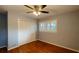 Bedroom featuring a ceiling fan, hardwood floors, a window and built-in closet at 2744 Hunting Hill Ln, Decatur, GA 30033