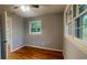 This bedroom offers hardwood floors and ample natural light from a large window at 2744 Hunting Hill Ln, Decatur, GA 30033