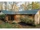 Charming brick home featuring a screened porch and mature landscaping, perfect for enjoying the outdoors at 2744 Hunting Hill Ln, Decatur, GA 30033