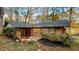 Back view of a charming brick home with a sliding glass door and lovely landscaping at 2744 Hunting Hill Ln, Decatur, GA 30033
