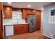 Bright kitchen featuring wooden cabinets, stainless steel refrigerator, and appliances, alongside white countertops at 2744 Hunting Hill Ln, Decatur, GA 30033