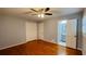 Spacious main bedroom featuring a ceiling fan, hardwood floors and an en suite bathroom at 2744 Hunting Hill Ln, Decatur, GA 30033