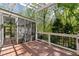 Exterior deck showing access to the screened-in porch and a railing overlooking the wooded backyard at 5533 Woodridge Ln, Douglasville, GA 30135
