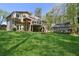 Expansive backyard featuring a large lush green lawn, a deck, and a charming screened-in porch for outdoor enjoyment at 5533 Woodridge Ln, Douglasville, GA 30135