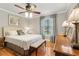 Bedroom with a decorative ceiling fan and hardwood floors at 5533 Woodridge Ln, Douglasville, GA 30135