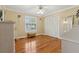 Bedroom with hardwood flooring, ceiling fan, and bright window shutters at 5533 Woodridge Ln, Douglasville, GA 30135