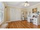 Bedroom with hardwood flooring, ceiling fan, and desk at 5533 Woodridge Ln, Douglasville, GA 30135