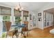 Cozy breakfast nook with a glass-top table, wicker chairs, wood floors, and bright, sunlit windows at 5533 Woodridge Ln, Douglasville, GA 30135