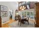 Elegant dining room with hardwood floors, a decorative chandelier, and views of the surrounding landscape at 5533 Woodridge Ln, Douglasville, GA 30135