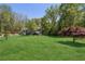 Expansive front lawn with mature trees provides privacy and a serene setting at 5533 Woodridge Ln, Douglasville, GA 30135