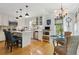 A spacious kitchen and dining area, featuring white cabinets, wood floors and abundant natural light at 5533 Woodridge Ln, Douglasville, GA 30135