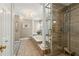 This ensuite bathroom features a standalone shower, a soaking tub with pillar, and a chandelier at 5533 Woodridge Ln, Douglasville, GA 30135