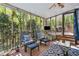 Relaxing sunroom featuring comfortable seating and views of the lush surrounding greenery at 5533 Woodridge Ln, Douglasville, GA 30135