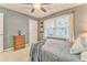 Bedroom features a ceiling fan, a dresser, and comfortable carpet at 825 Clarion Way, Lawrenceville, GA 30044