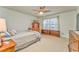 Bright bedroom with a ceiling fan, a window with natural light, and comfortable carpet at 825 Clarion Way, Lawrenceville, GA 30044