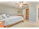 Cozy bedroom features a ceiling fan, built-in bookshelf, neutral walls, and comfortable carpet at 825 Clarion Way, Lawrenceville, GA 30044
