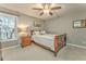 Cozy bedroom with wood furniture, natural light, and neutral paint at 825 Clarion Way, Lawrenceville, GA 30044