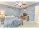 Bedroom features a ceiling fan, a desk, and comfortable carpet at 825 Clarion Way, Lawrenceville, GA 30044
