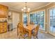 Dining area with wooden table and chairs near large windows, with views of the back yard at 825 Clarion Way, Lawrenceville, GA 30044