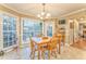 Dining area featuring large windows providing lots of natural light, a wooden table, and four chairs at 825 Clarion Way, Lawrenceville, GA 30044