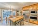 A modern kitchen with stainless steel appliances, a center island, and a dining area at 825 Clarion Way, Lawrenceville, GA 30044