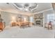 Spacious main bedroom with stone fireplace, tray ceiling, and cozy furniture at 825 Clarion Way, Lawrenceville, GA 30044