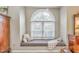 A cozy window seat nook features an arched window and neutral decor at 825 Clarion Way, Lawrenceville, GA 30044
