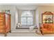 A cozy window seat is framed by an arched window for natural light and relaxed moments at 825 Clarion Way, Lawrenceville, GA 30044