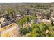 An aerial view of a neighborhood with tree-lined streets and single-Gathering homes at 2694 Hickory Valley Dr, Snellville, GA 30078