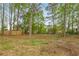 Spacious grassy backyard and wooded lot with privacy fence at 2694 Hickory Valley Dr, Snellville, GA 30078