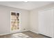 Bedroom features a large window, closet, and light gray wood-look flooring at 2694 Hickory Valley Dr, Snellville, GA 30078