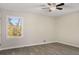 Bright bedroom features a ceiling fan, window, and light gray wood-look flooring at 2694 Hickory Valley Dr, Snellville, GA 30078