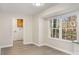 Bright dining area with natural lighting from the large window and an adjacent laundry room at 2694 Hickory Valley Dr, Snellville, GA 30078