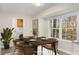 Bright dining area with natural lighting from the large window and an adjacent laundry room at 2694 Hickory Valley Dr, Snellville, GA 30078
