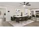 Open dining room with a large dining table with gray marble top adjacent to a modern kitchen at 2694 Hickory Valley Dr, Snellville, GA 30078