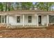 Charming front porch with stone base, white railings, and decorative front door at 2694 Hickory Valley Dr, Snellville, GA 30078