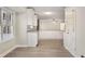 Spacious kitchen with granite countertops, white cabinets, and a doorway leading outside at 2694 Hickory Valley Dr, Snellville, GA 30078