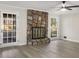 Cozy living room featuring stone fireplace, ceiling fan and large window with natural light at 2694 Hickory Valley Dr, Snellville, GA 30078