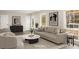 Staged living room featuring neutral decor, modern furnishings, and ample natural light at 2694 Hickory Valley Dr, Snellville, GA 30078